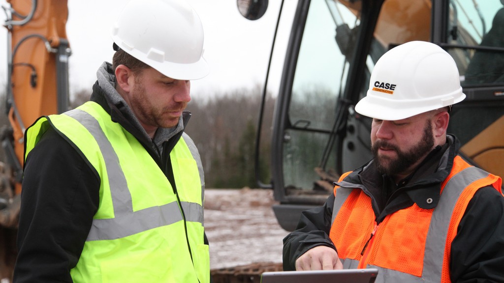 two Case workers discuss information on sitewatch tablet app