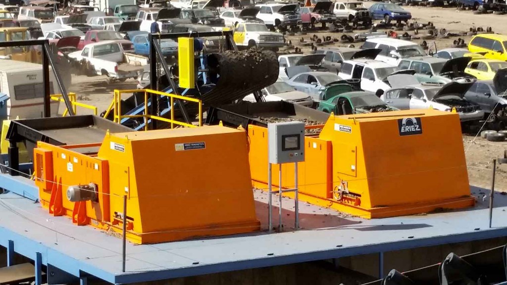 Eriez eddy current separator on a loading bay next to a junkyard