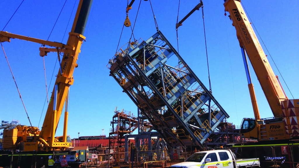 Cranes lifting a structure