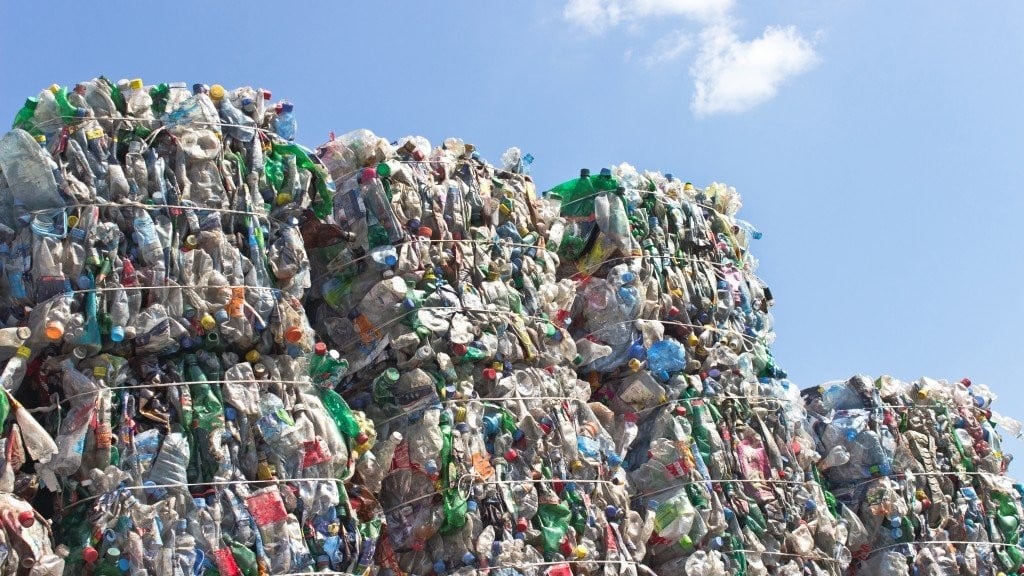 large plastic waste bales tied together in an open space
