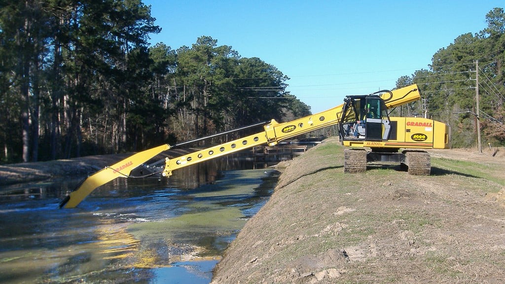 Gradall telescoping boom working  in a river