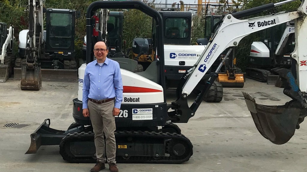 man stands in from of Copper Equipment Rentals Bobcat machine