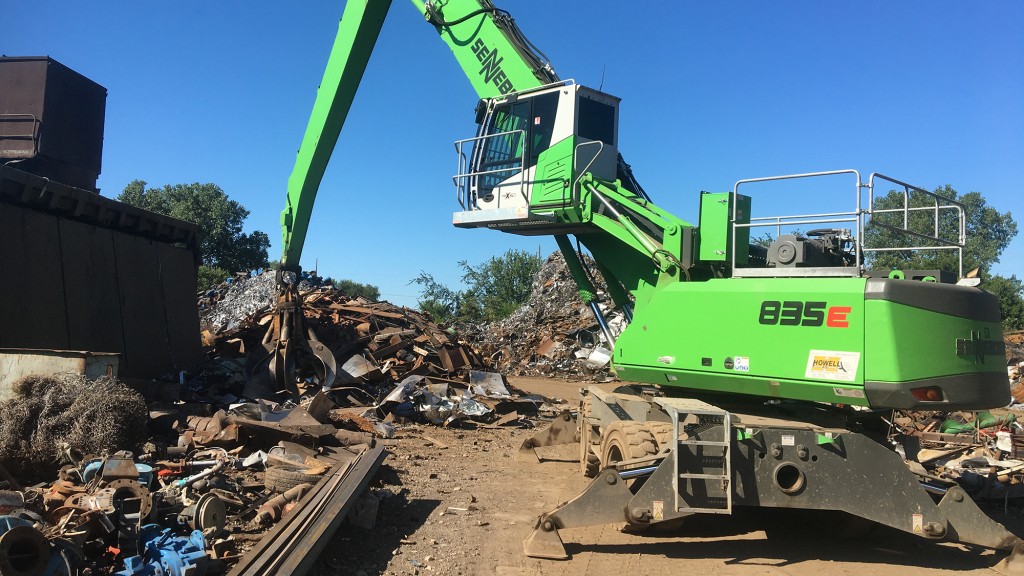 Sennebogen scrap handler in operation in a scrap yard