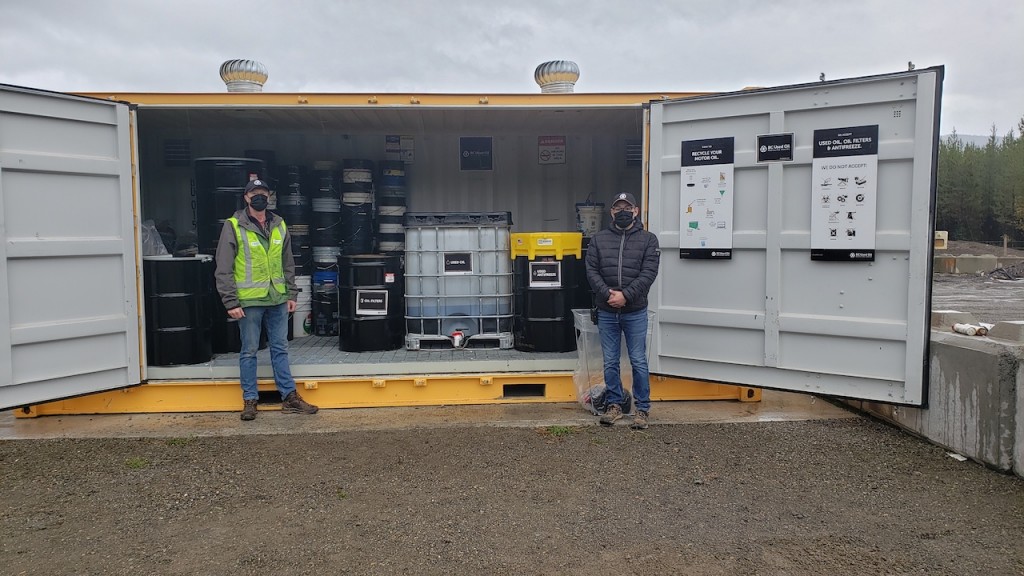 two men stand in front of BCUOMA facility