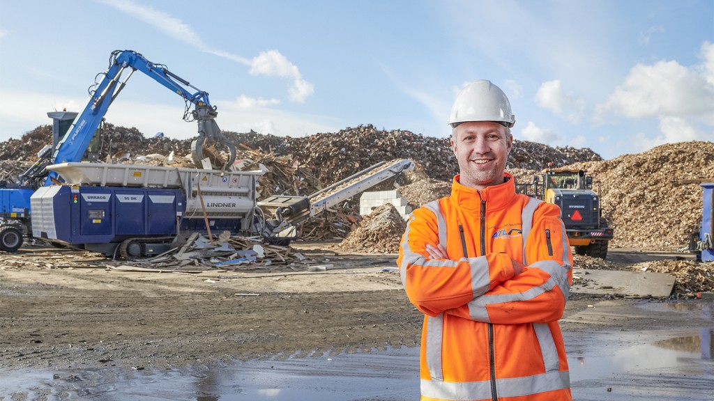 man stands in front of Lindner machine on a worksite