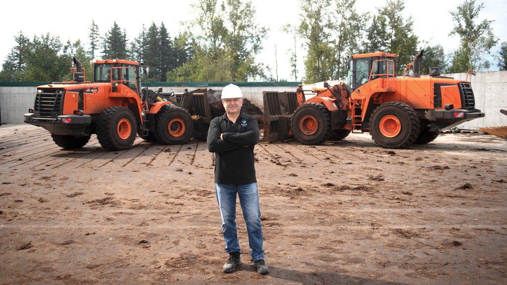 Zelko Fuduric, GM and facility director at Central Composting in Abbotsford, B.C., with Doosan DL420-3 and DL420-5 wheel loaders outfitted with forked buckets.