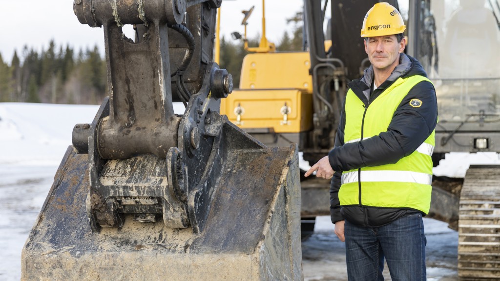 Stig Engström, owner and founder of Engcon, standing next to a machine