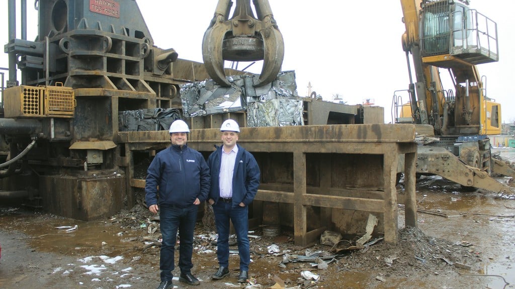Andy Racco and Frank Ruffolo at Ram Iron & Metal in Ontario, in front of their Harris shear-top ferrous baler and Liebherr material handler with magnet grapple.