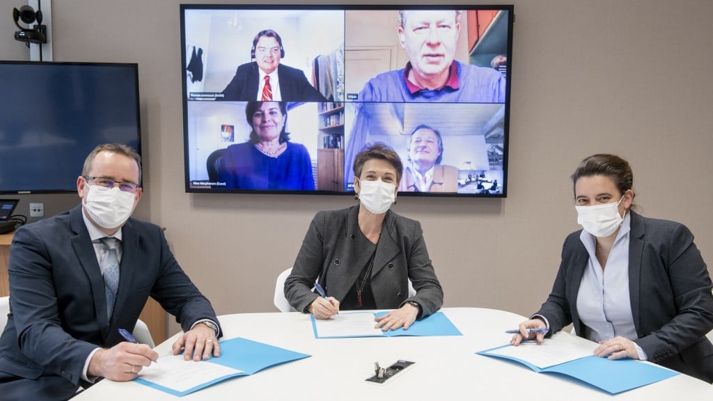 3 people sign an agreement via a zoom call