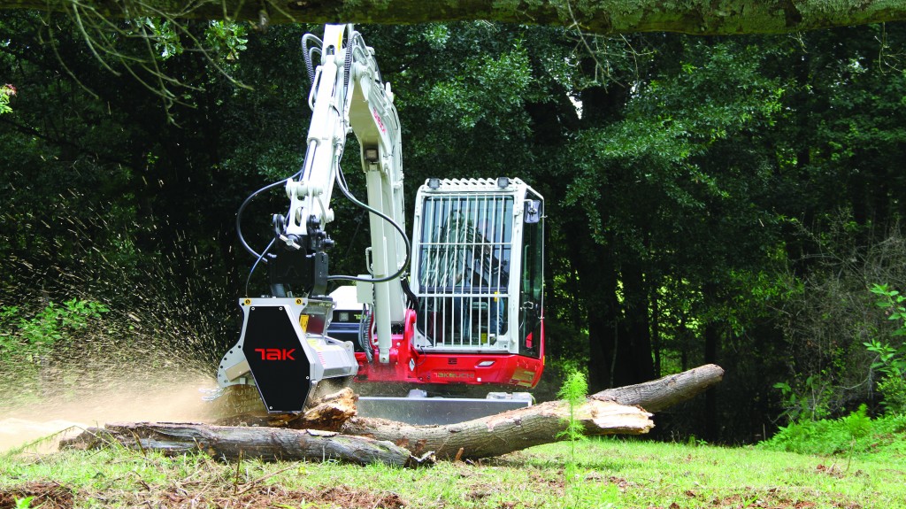 Takeuchi tb 370 mulching head on a skid steer in the forest