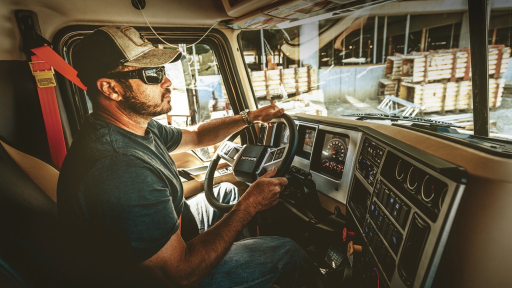 man behind the wheel of Mack truck