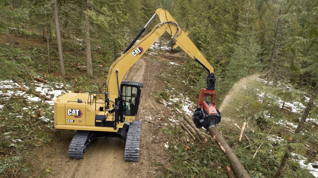 Cat 538 forest machine at work in forest listing logs