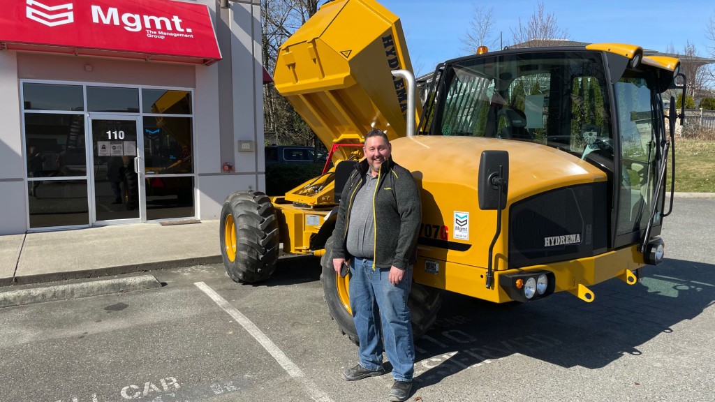 man standing in front of hydra machine outside of MGMT office