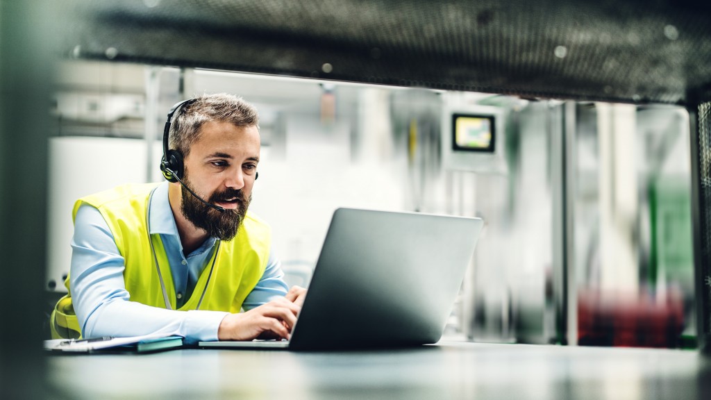 customer service agent types on computer with headset customer service agent types on computer with headset