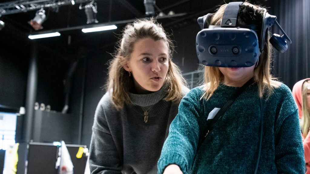 woman oversees a child using VR