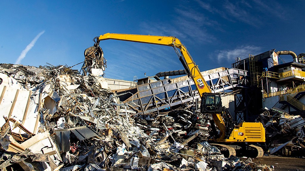 Cat material handler in scrapyard