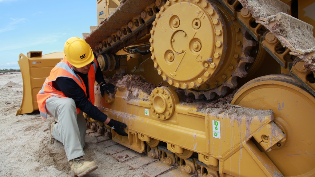 technician working on Cat undercarriage