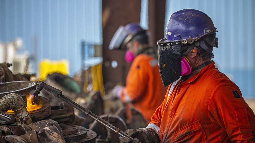 men welding in a shipyard