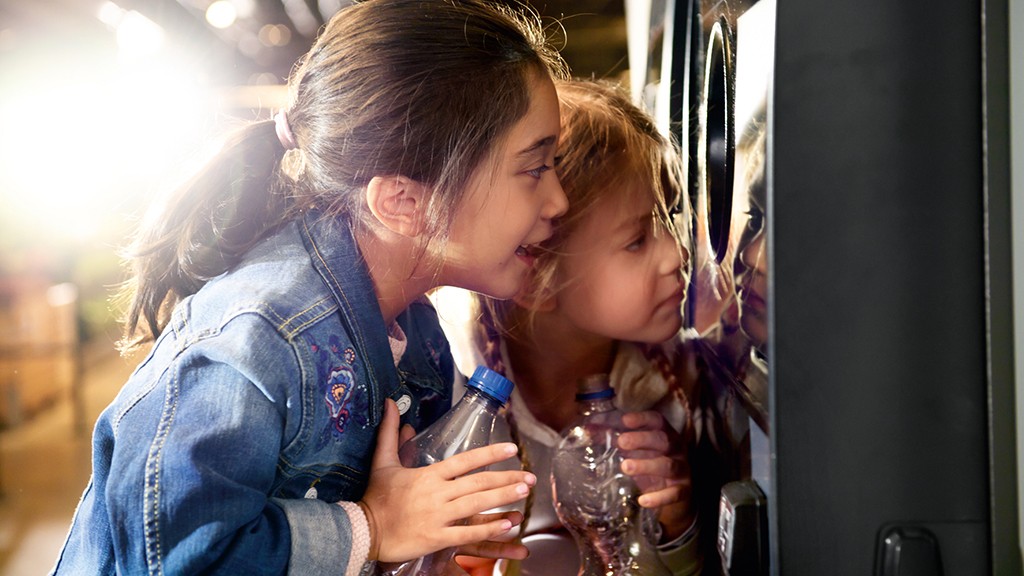 Kids looking at a reverse vending machine