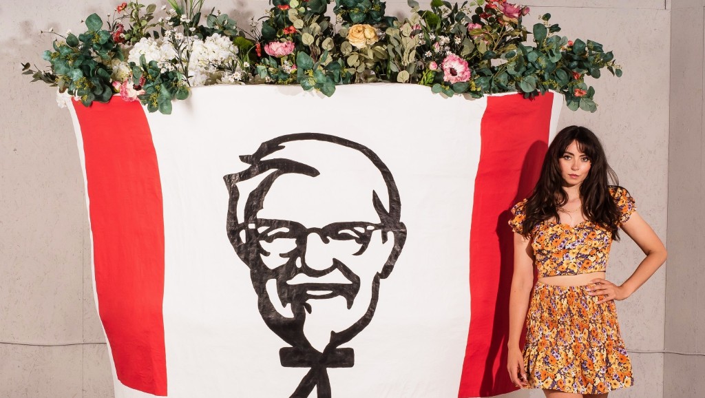 Briony Douglas stands next to her KFC art installation