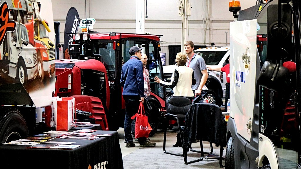 People looking at heavy equipment at a trade show