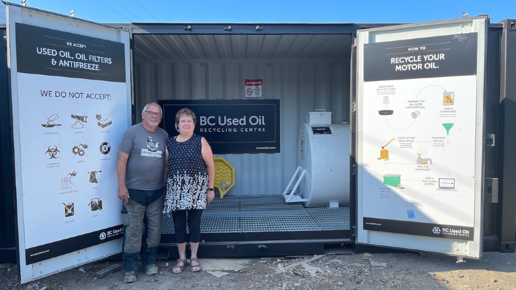 Owners stand in front of their used oil recycling center