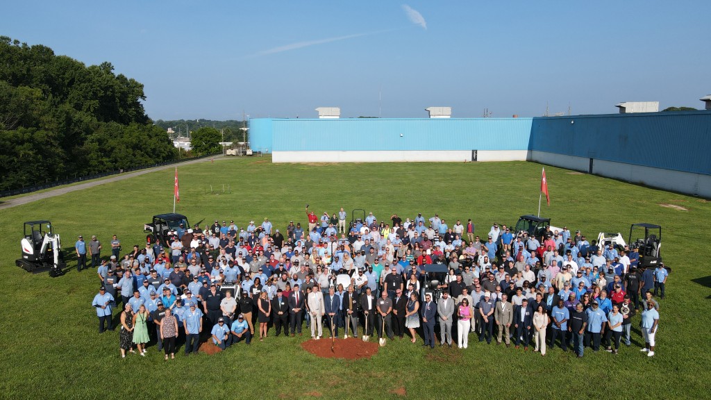 Employees, officials and community and business leaders pose for an aerial photo.