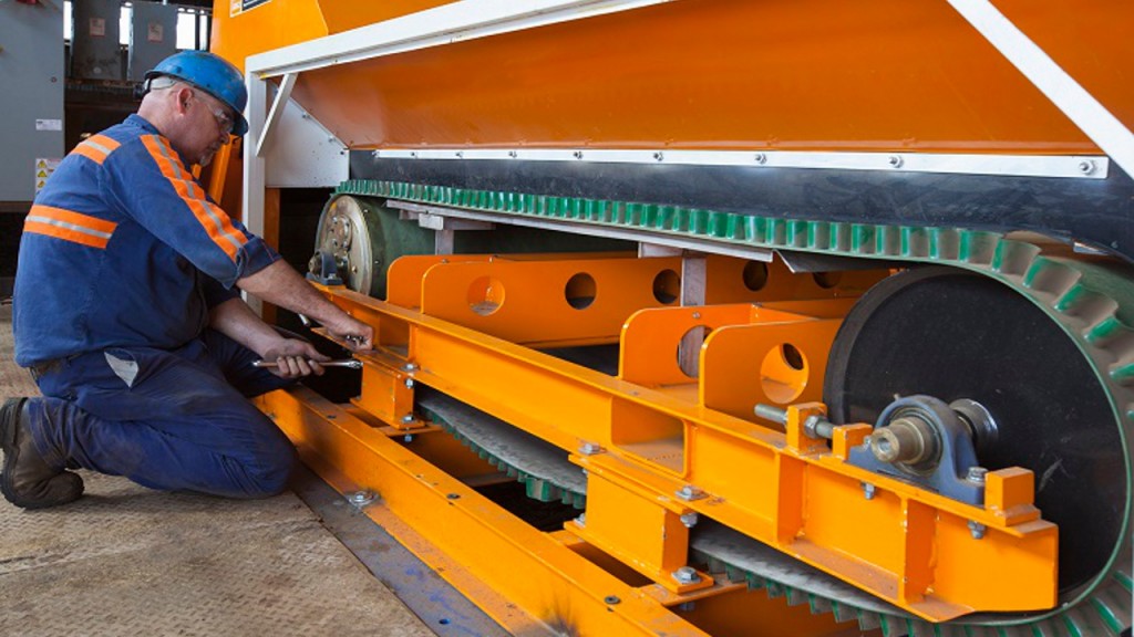 Worker performs maintenance on Eriez equipment.