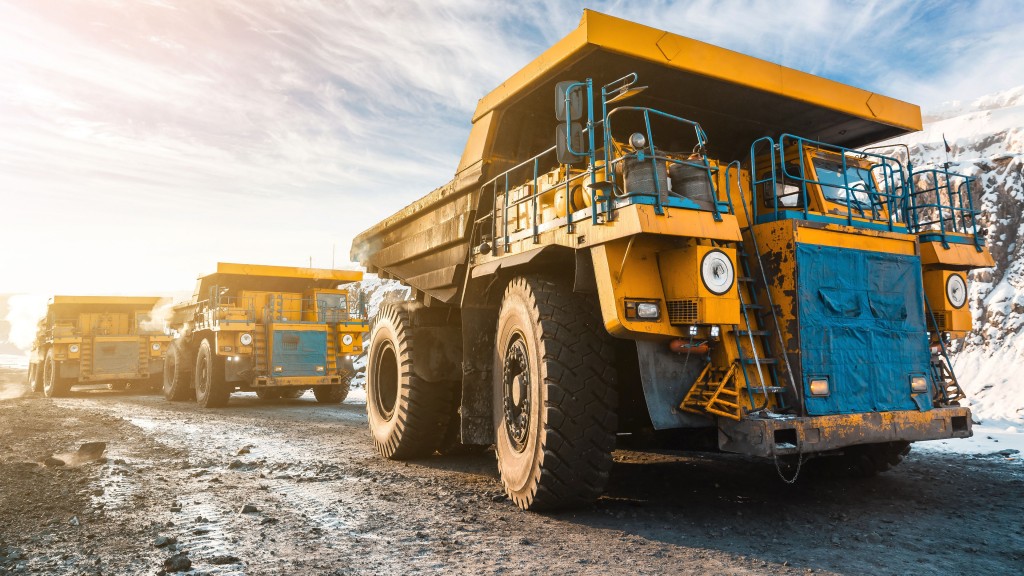 Three mining trucks in a row on a job site