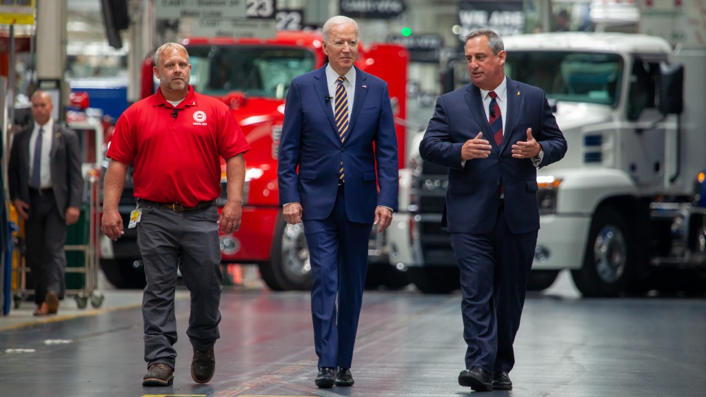 Biden and Mack Truck employees walking through Mack's facility.