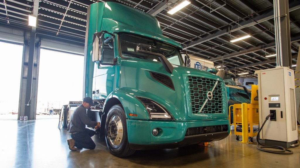 A technician repairs a Volvo VNR Electric