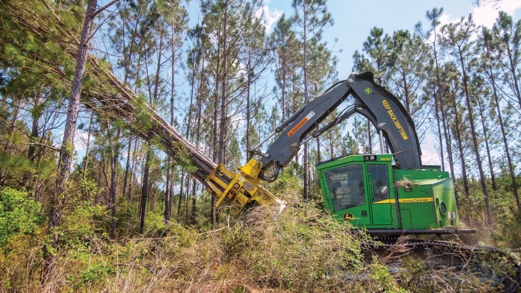 An 853M forestry machine felling trees.