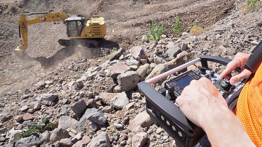 An operator controls an excavator remotely on-site