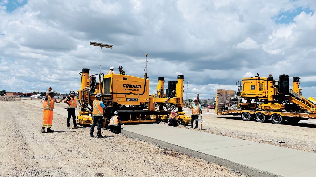 A GOMACO curb and gutter machine paving a concrete dolly pad