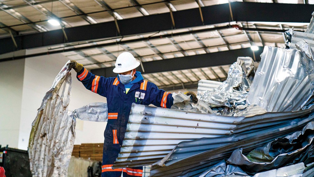 Scrap University student handling scrap metal.