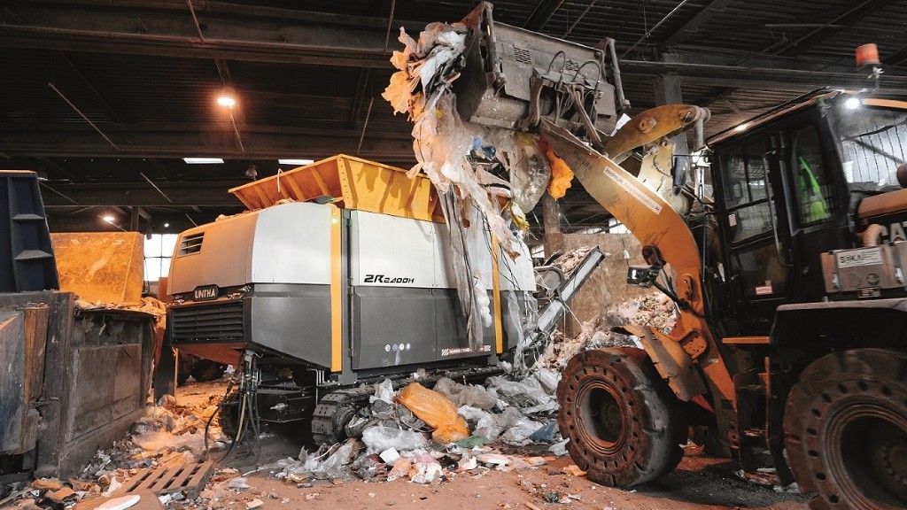 A two shaft shredder getting filled on the job site