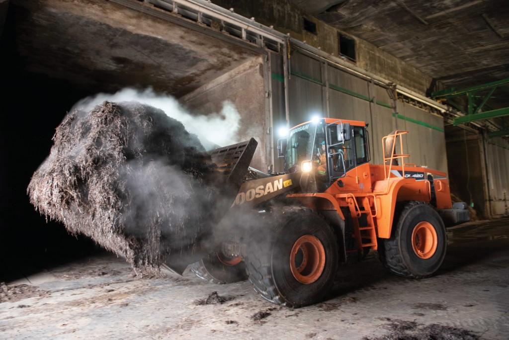 A Doosan wheel loader moving compost