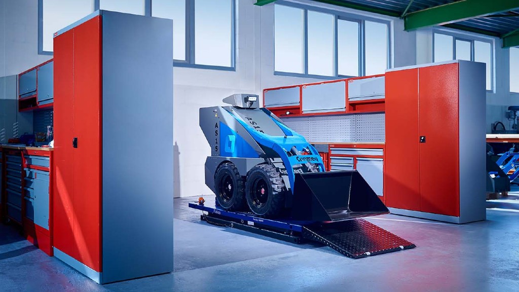 An AS15 skid-steer loader parked in a maintenance shop