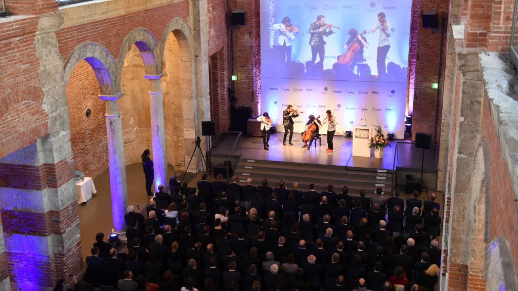 A string band plays on a bauma stage