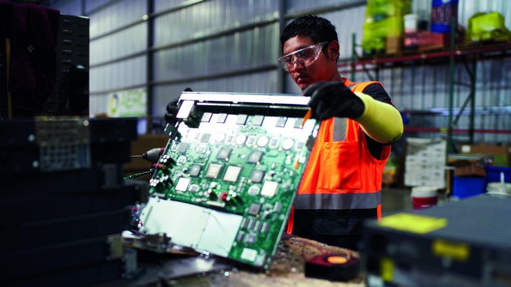 A worker handles a circuit board