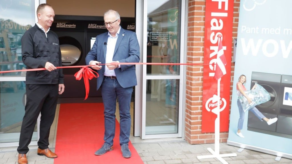 A reverse vending machine undergoes a ribbon cutting ceremony