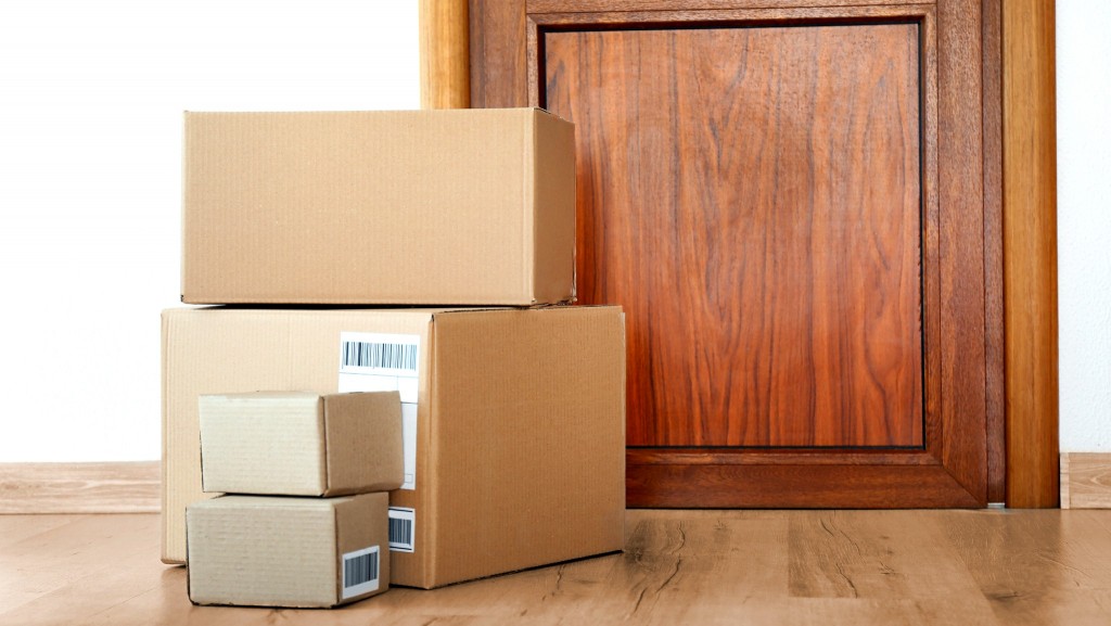 Cardboard boxes piled near a door