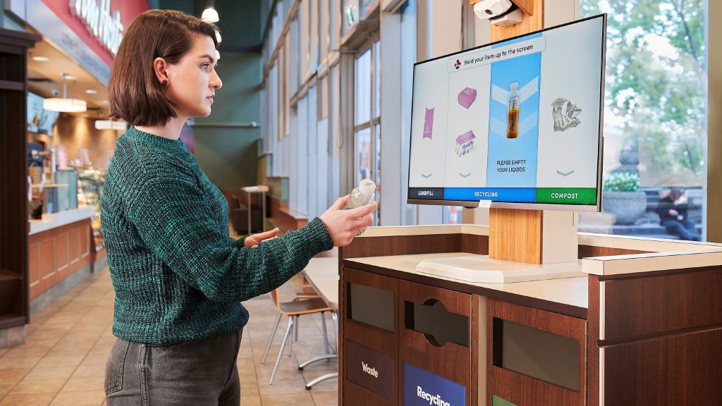 A woman uses AI-based recycling at Tim Hortons