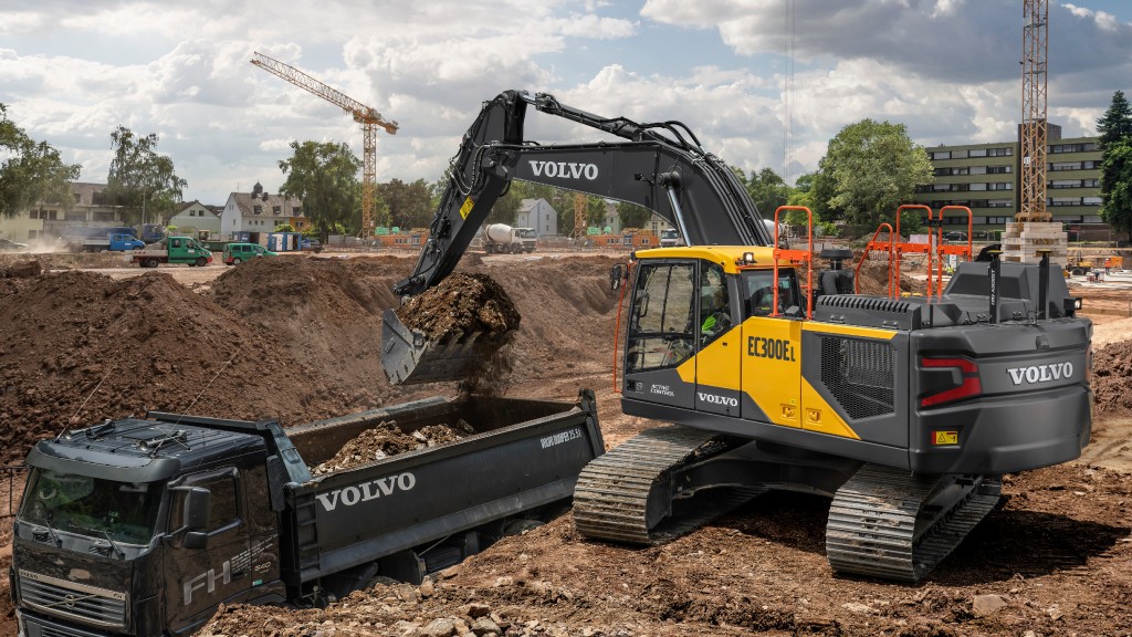 A Volvo excavator loading a truck from a bank