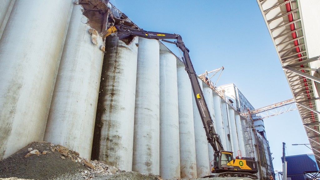 Volvo demolition excavator tears down grain elevator