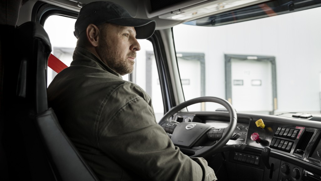 A driver drives a Volvo truck