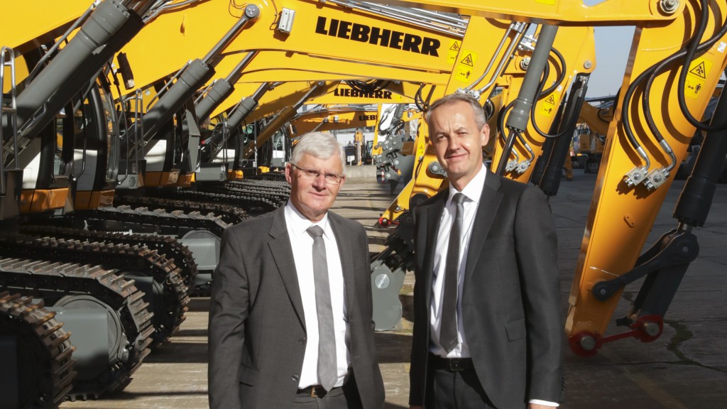 Christophe Sanchez and Martin Schickel standing under Liebherr machines