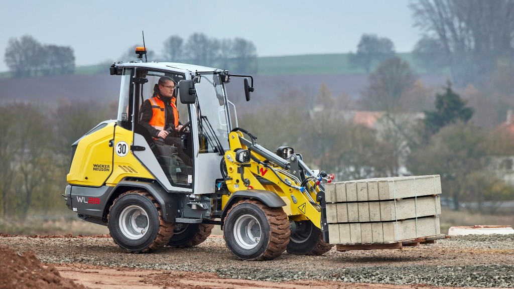 A wheel loader moving building supplies on a job site