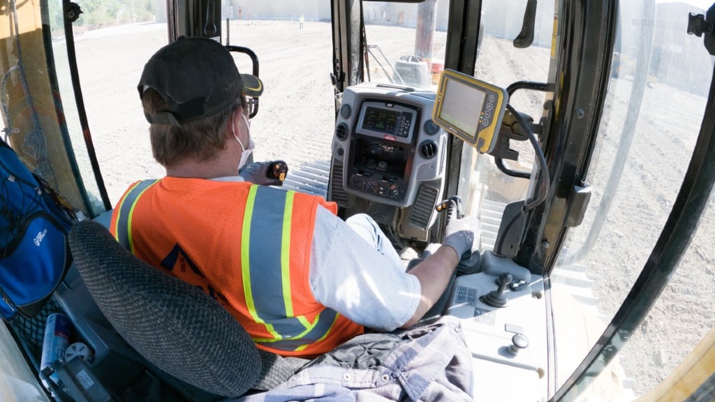An operator uses a Topcon machine control system on the job site