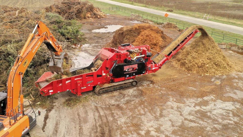 A Rotochopper horizontal grinder grinds wood waste